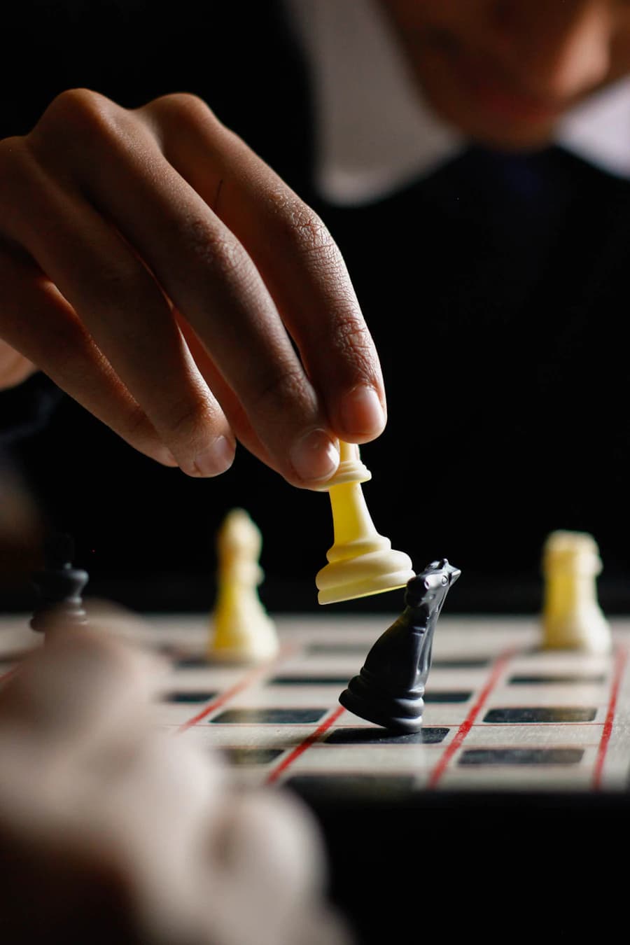A hand moving a white piece