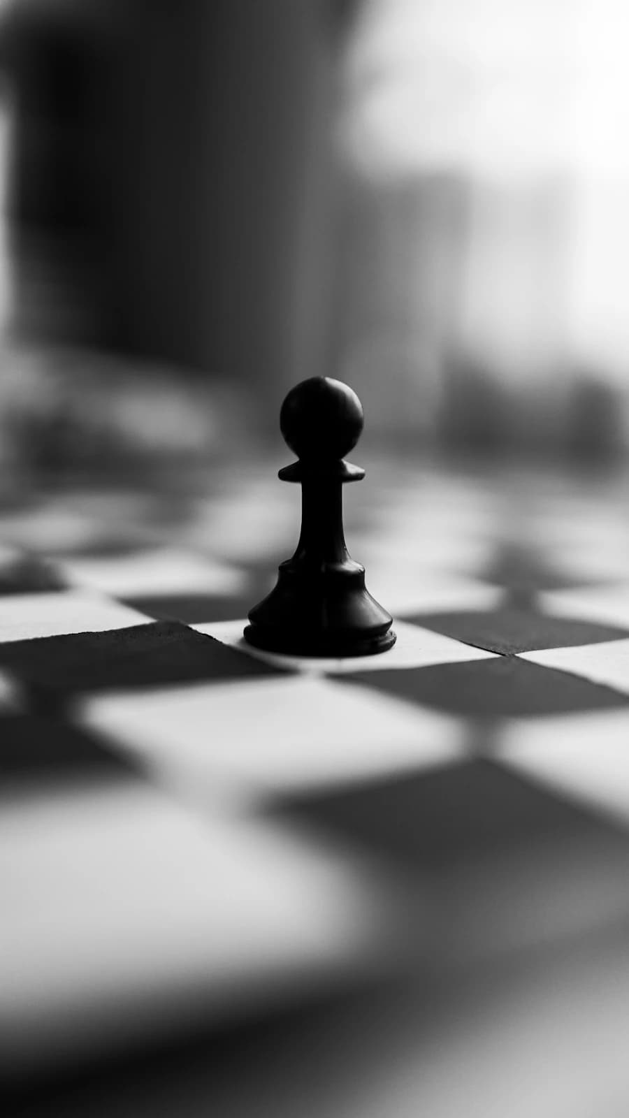 A black piece on a checkered surface