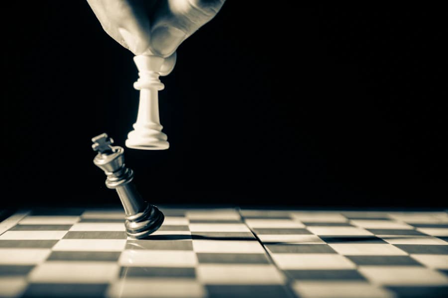 A hand holding a white king above the board