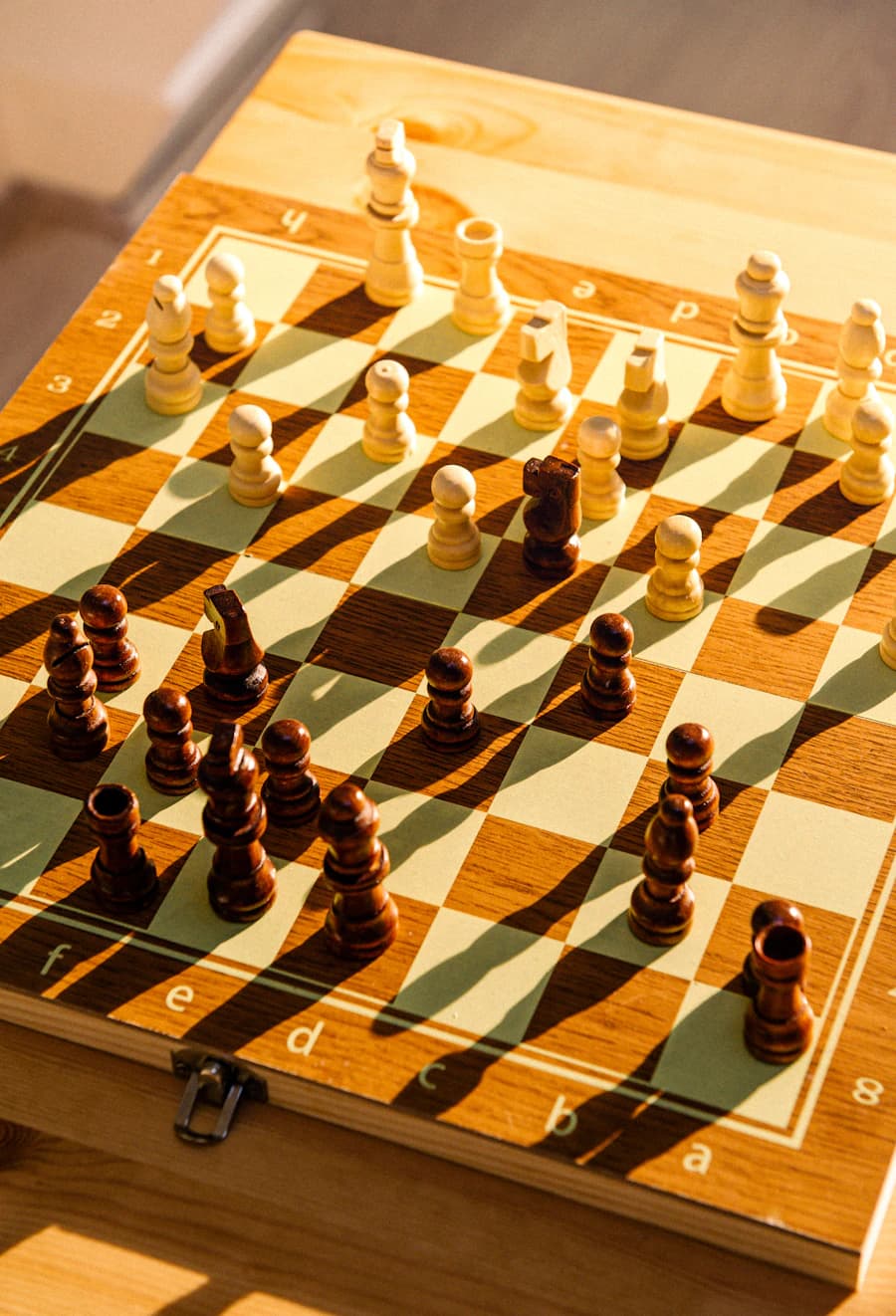 A wooden chessboard with pieces